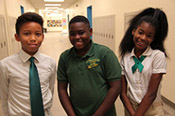 Three kids in a school hallway
